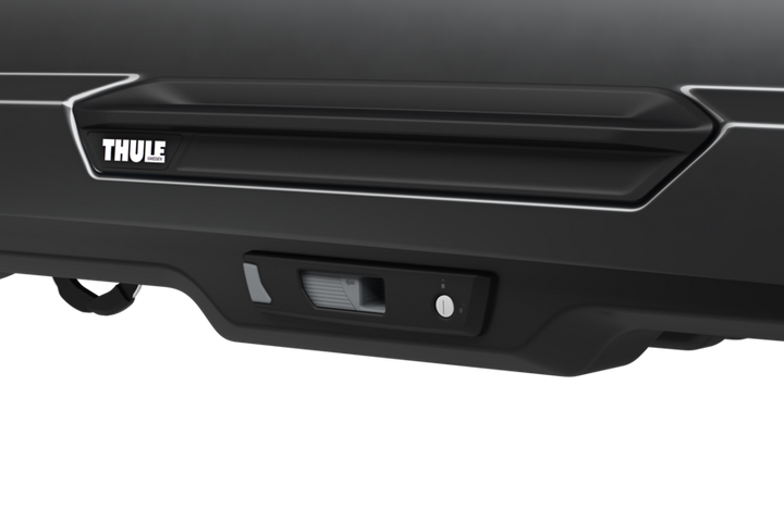 Close-up of Thule Motion 3 XL Low roof cargo box mounted on a vehicle roof rack system